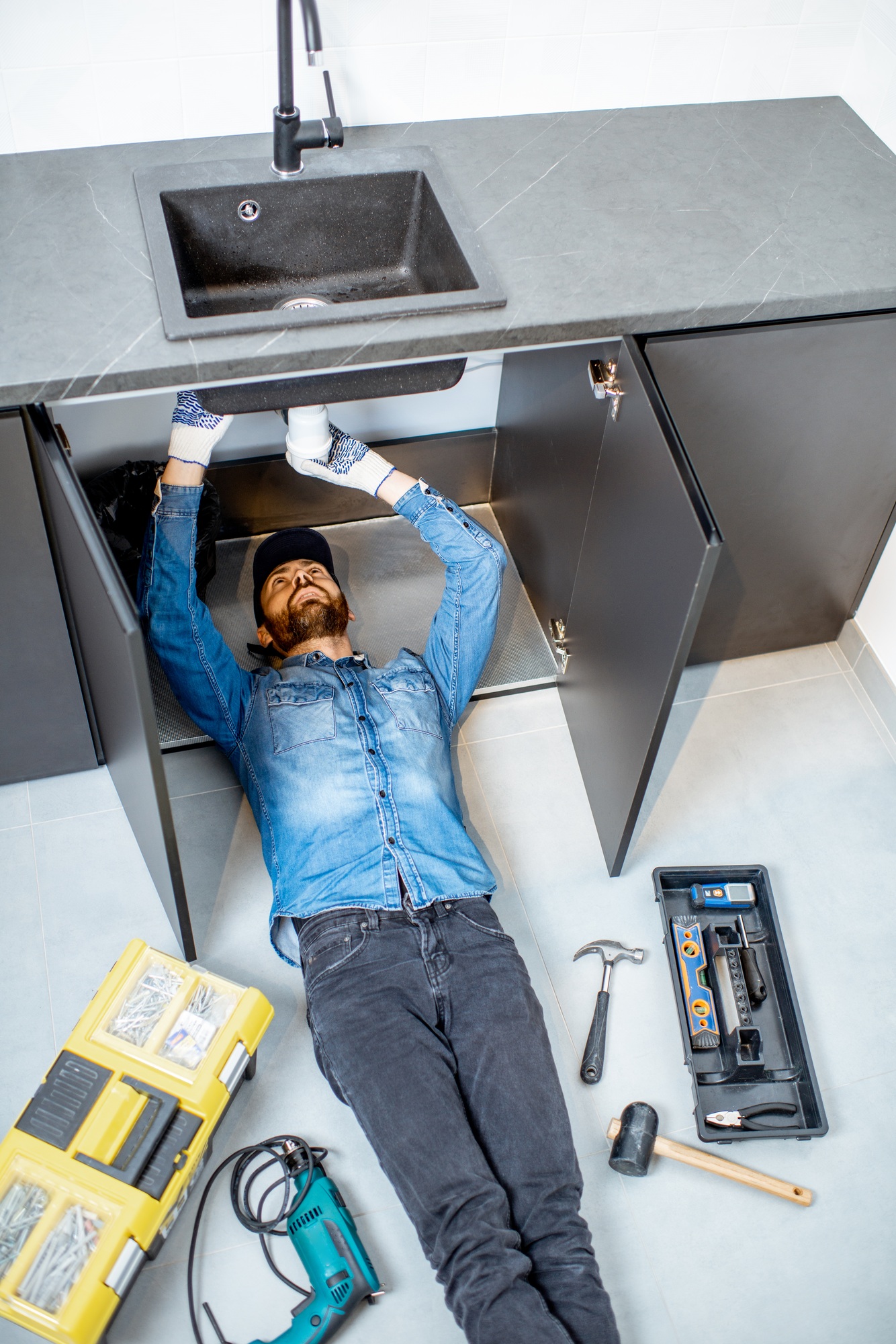 Man repairing kitchen plumbing